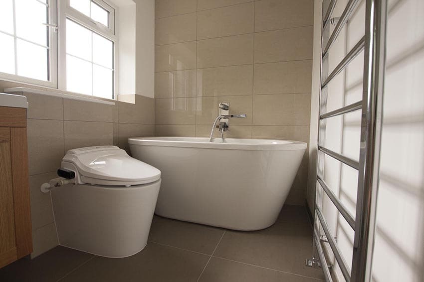 Freestanding bath with bidet toilet in a luxury bathroom renovation by The Wetherby Plumber