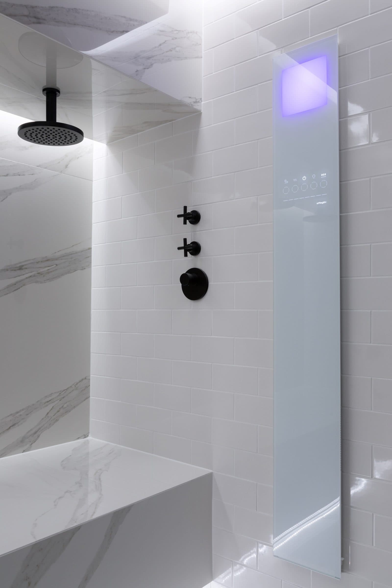 Luxury steam shower with marble tiles and LED lighting installed by The Wetherby Plumber