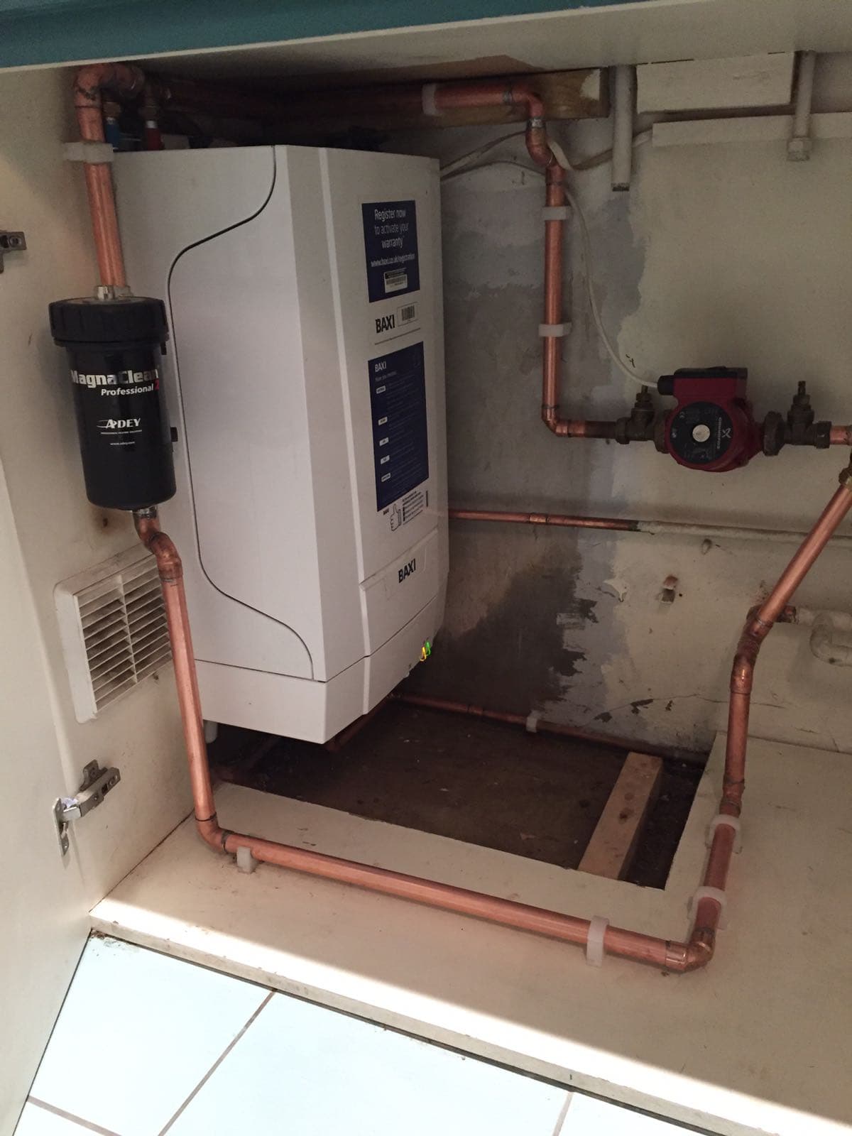 Baxi boiler with MagnaClean filter in a tidy airing cupboard by The Wetherby Plumber